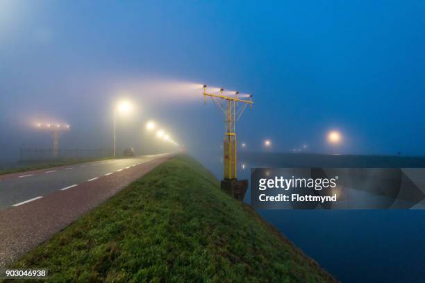 schiphol runway and fog, netherlands - haarlemmermeer stock pictures, royalty-free photos & images