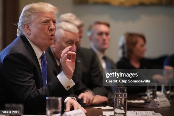 President Donald Trump presides over a meeting about immigration with Republican and Democrat members of Congress in the Cabinet Room at the White...