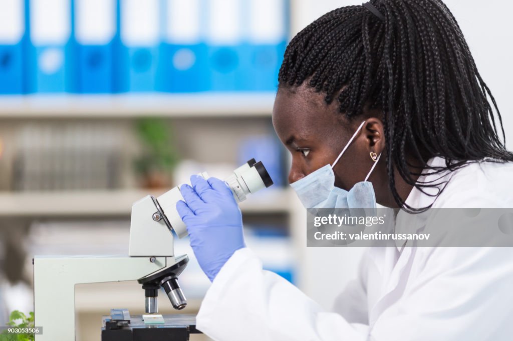 Female Laboratory Worker Using Microscope High-Res Stock Photo - Getty ...