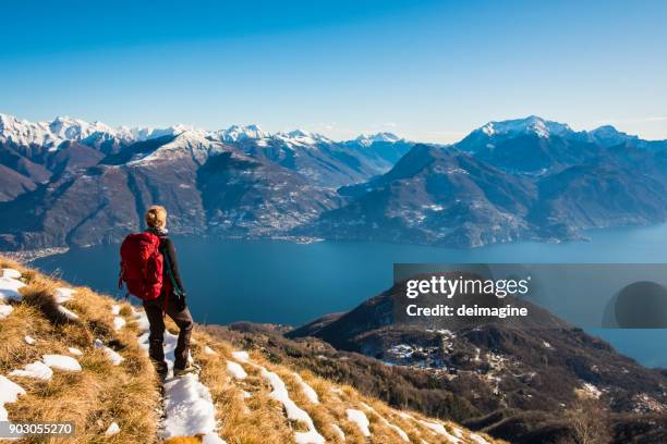 woman hiker on mountain looking at lake - winter panoramic stock pictures, royalty-free photos & images