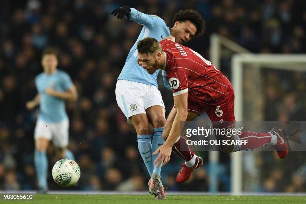 Bristol City's English defender Nathan Baker vies with Manchester City's German midfielder Leroy Sane during the English League Cup semi-final first...