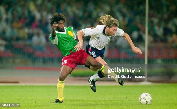 England winger Chris Waddle is challenged by Jean-Claude Pagal of Cameroon during the 1990 FIFA World Cup Quarter Final match on July 1, 1990 in...