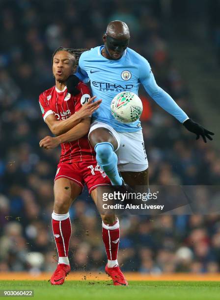 Eliaquim Mangala of Manchester City and Bobby Reid of Bristol City battle for the ball during the Carabao Cup Semi-Final First Leg match between...