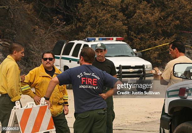 Forest Service firefighters and law enforcement officials investigate the ignition point of the Station Fire on Angeles Crest Highway September 2,...