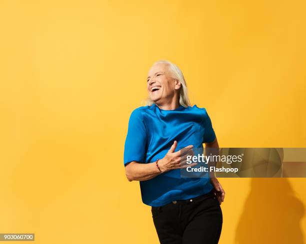 portrait of mature woman dancing, smiling and having fun - old woman dancing bildbanksfoton och bilder