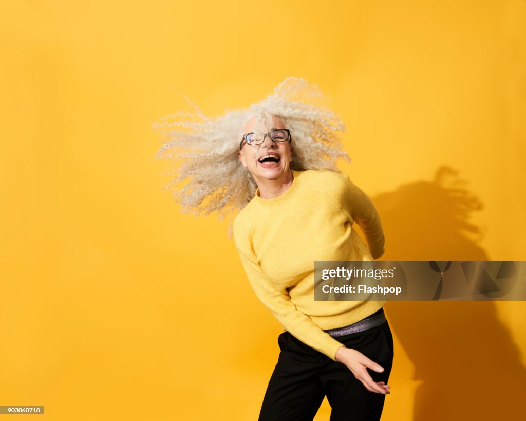 Portrait of mature woman dancing, smiling and having fun