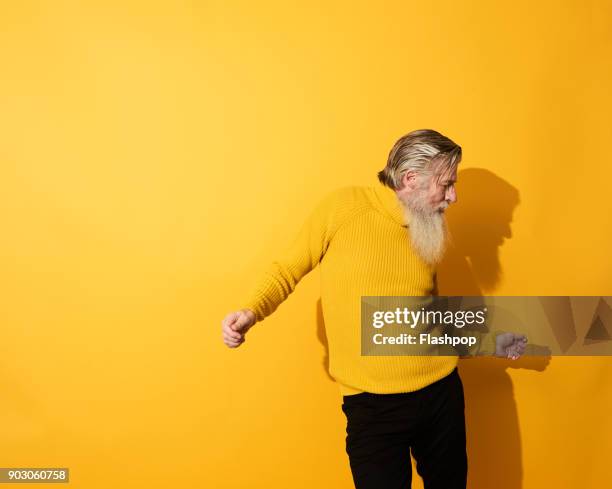 portrait of mature man dancing and having fun - dans kleur stockfoto's en -beelden
