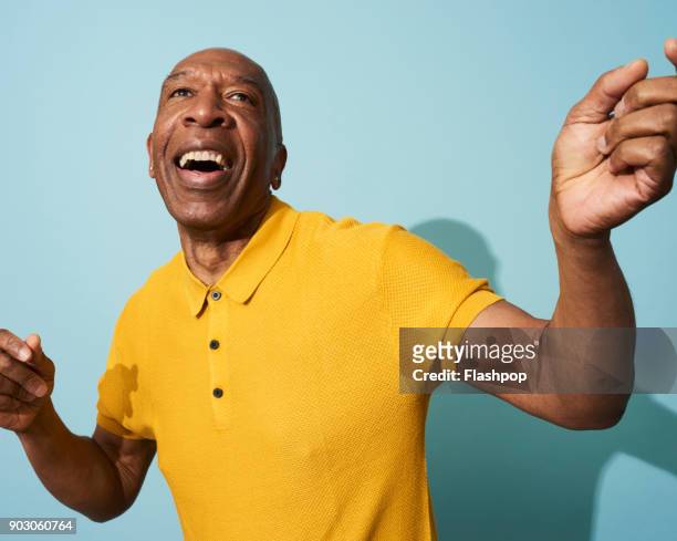 portrait of a mature man dancing, smiling and having fun - carefree stock pictures, royalty-free photos & images