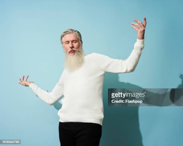 portrait of mature man dancing and having fun - barba peluria del viso foto e immagini stock