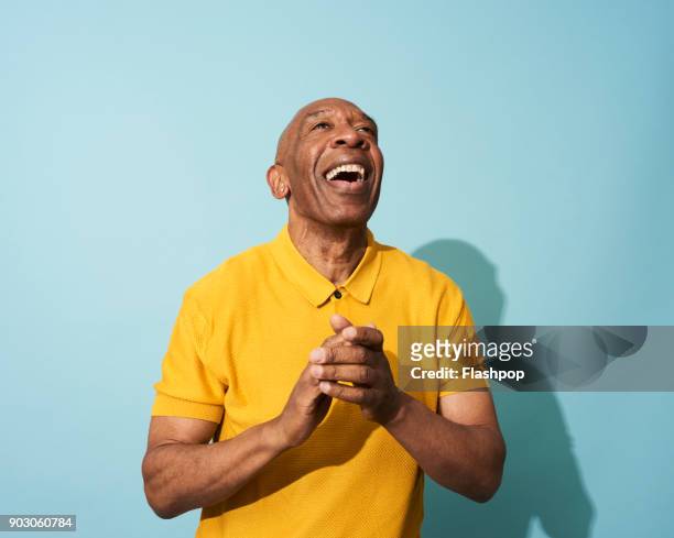 portrait of a mature man dancing, smiling and having fun - waist up stock pictures, royalty-free photos & images