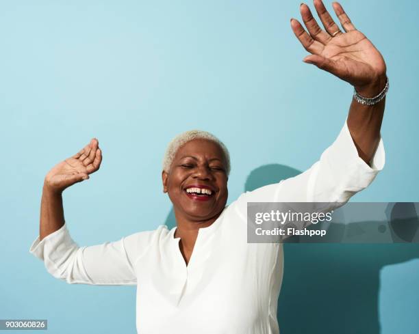 portrait of mature woman dancing, smiling and having fun - best animated short film stock-fotos und bilder