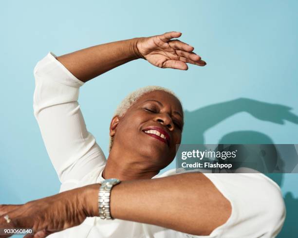 portrait of mature woman dancing, smiling and having fun - short dance stock pictures, royalty-free photos & images