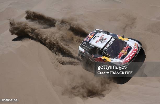 Peugeot's French driver Sebastien Loeb and co-driver Daniel Elena of Monaco compete during the Stage 4 of the 2018 Dakar Rally in and around San Juan...