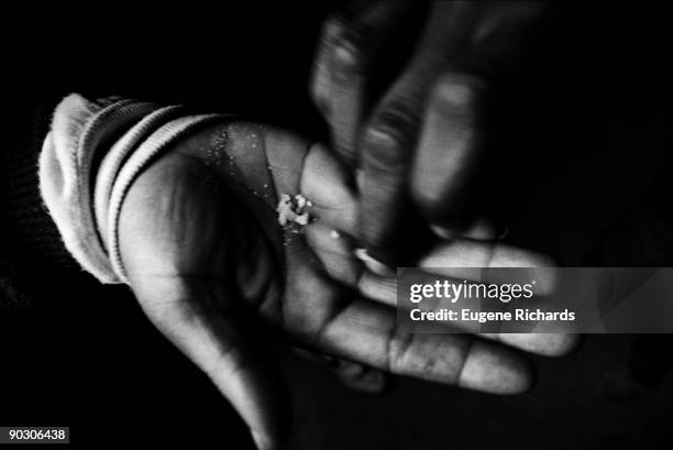 Close-up of hands as one person offers crack to another in the hallway of the Red Hook Houses Brooklyn, New York, New York, April 1988. The photo was...