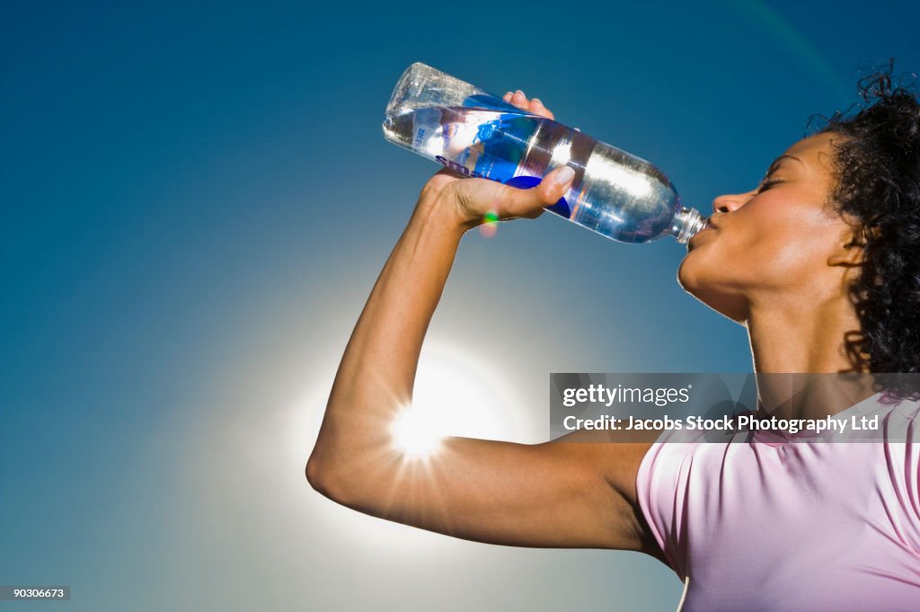 African woman drinking water