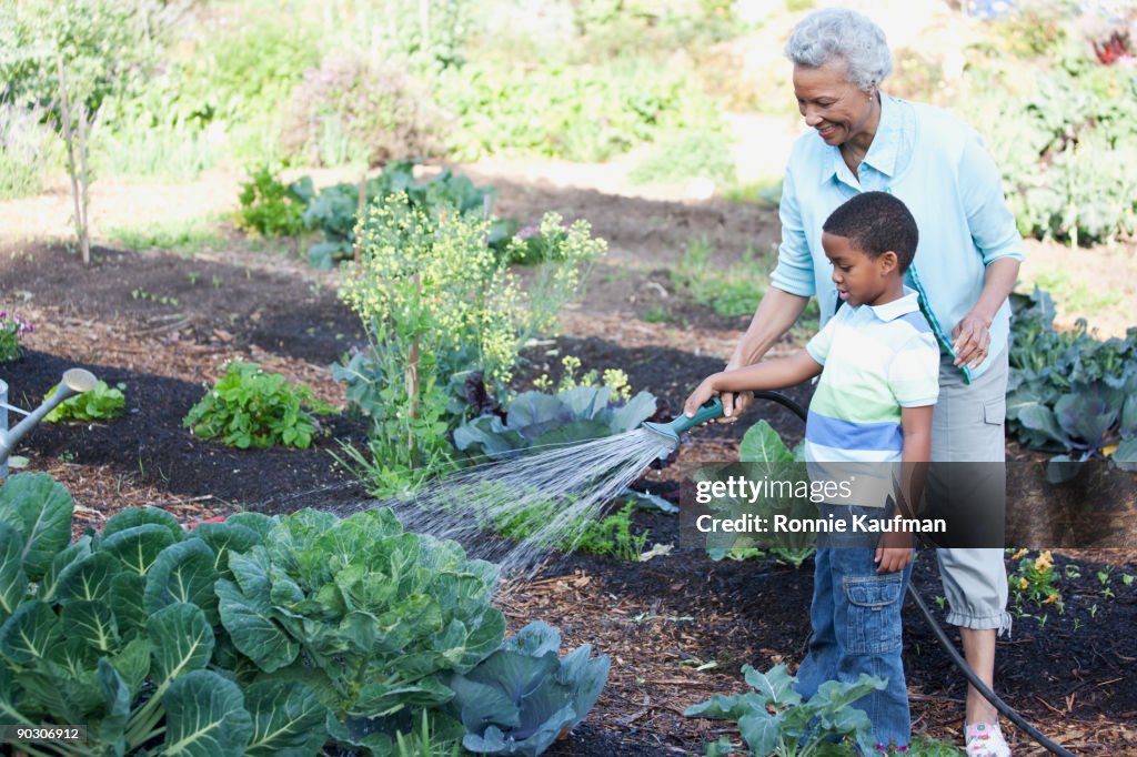 African grandmother gardening with grandson