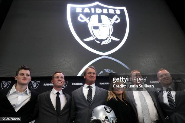 Oakland Raiders new head coach Jon Gruden poses for a photo with members of his family during a news conference at Oakland Raiders headquarters on...