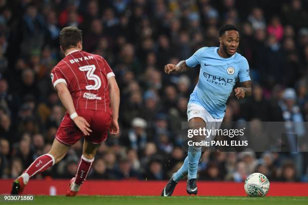 Manchester City's English midfielder Raheem Sterling vies with Bristol City's Scottish defender Joe Bryan during the English League Cup semi-final...