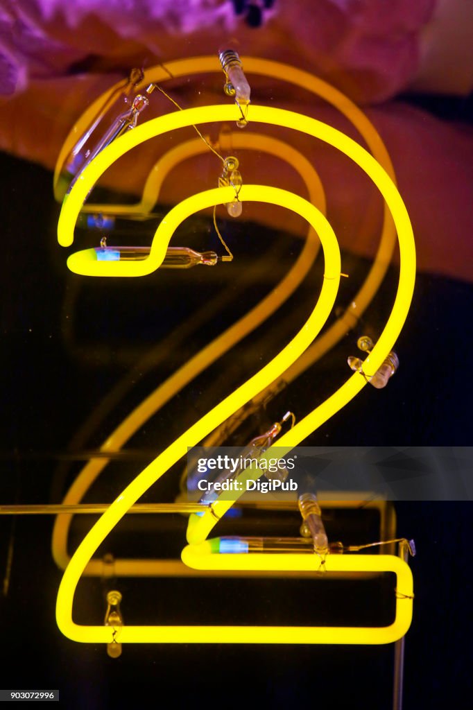 Yellow neon sign number '2'