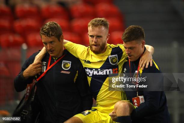 Connor Pain of the Mariners is carried from the field during the round 15 A-League match between the Newcastle Jets and the Central Coast Mariners at...