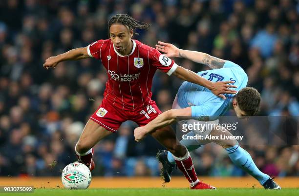 John Stones of Manchester City and Bobby Reid of Bristol City tussle for the ball during the Carabao Cup Semi-Final First Leg match between...
