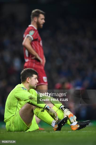 Bristol City's English goalkeeper Frank Fielding reacts after they concede a late goal during the English League Cup semi-final first leg football...