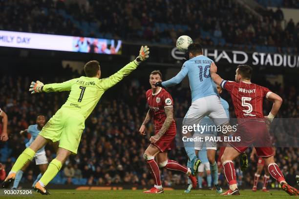 Manchester City's Argentinian striker Sergio Aguero jumps to score their late winning goal during the English League Cup semi-final first leg...