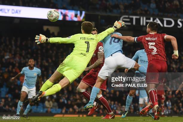 Manchester City's Argentinian striker Sergio Aguero jumps to score their late winning goal during the English League Cup semi-final first leg...
