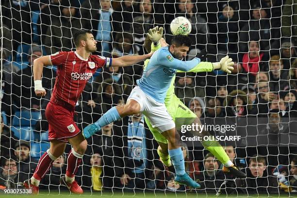 Manchester City's Argentinian striker Sergio Aguero jumps to score their late winning goal during the English League Cup semi-final first leg...