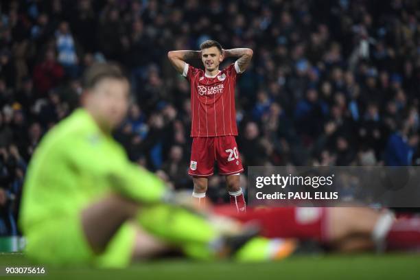 Bristol City's English midfielder Jamie Paterson reacts after they concede a late goal during the English League Cup semi-final first leg football...