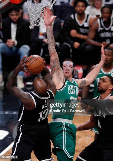 Daniel Theis of the Boston Celtics`defends against Quincy Acy of the Brooklyn Nets in an NBA basketball game on January 6, 2018 at Barclays Center in...