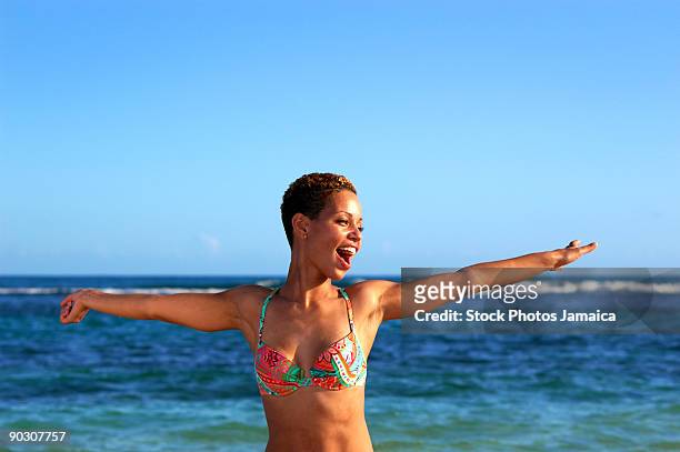 happy girl play dancing at the beach - jamaica dance stock pictures, royalty-free photos & images