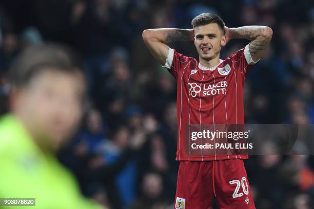 Bristol City's English midfielder Jamie Paterson reacts after they concede a late goal during the English League Cup semi-final first leg football...