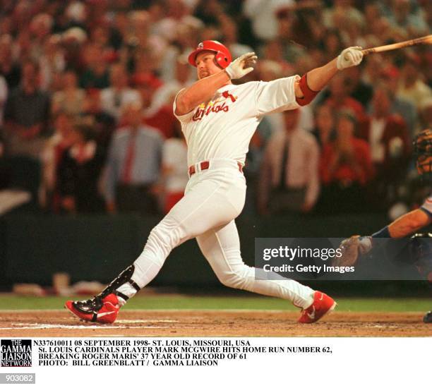 St. Louis Cardinals'' Mark McGwire takes a big swing as he watches history being made, with his 341-foot-62nd home run of the season in the fourth...