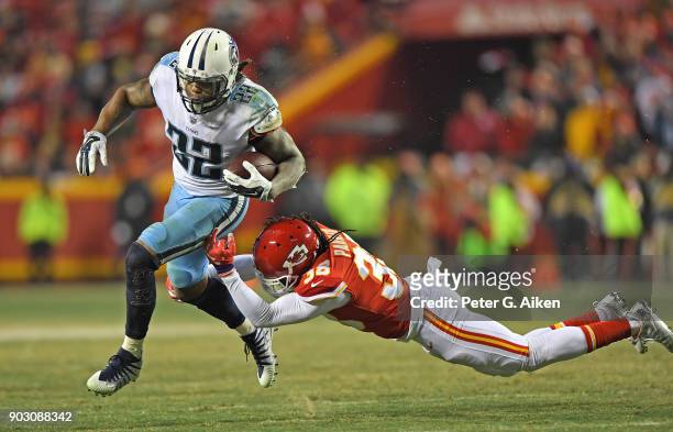 Running back Derrick Henry of the Tennessee Titans runs up field during the second half of the game against free safety Ron Parker of the Kansas City...