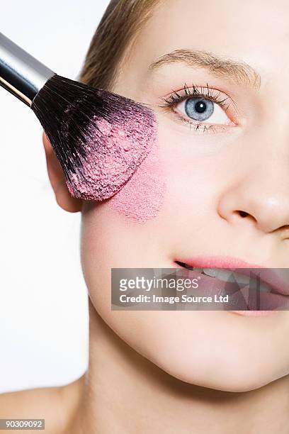 woman with blusher on cheek - applying makeup with brush stock pictures, royalty-free photos & images