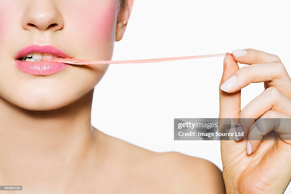Woman pulling gum out of her mouth