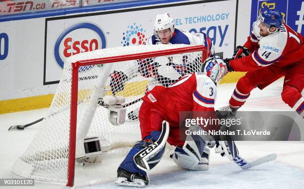 Adam Fox of United States skates the puck behind the Czech Republic net with Ondrej Vala of Czech Republic defending the play during the first period...
