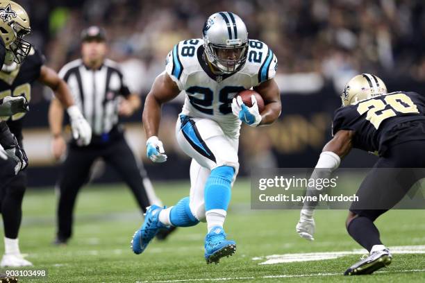 Jonathan Stewart of the Carolina Panthers runs the ball against Ken Crawley of the New Orleans Saints during the first half of the NFC Wild Card...