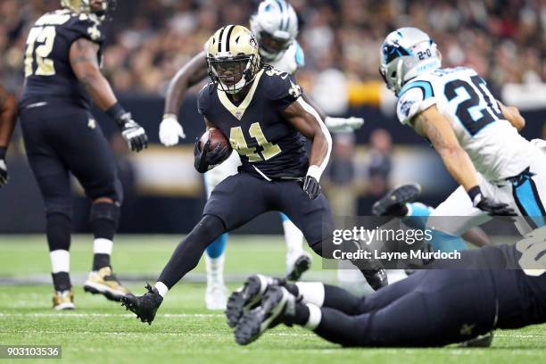 Tommylee Lewis of the New Orleans Saints runs the ball against Kurt Coleman of the Carolina Panthers during the first half of the NFC Wild Card...