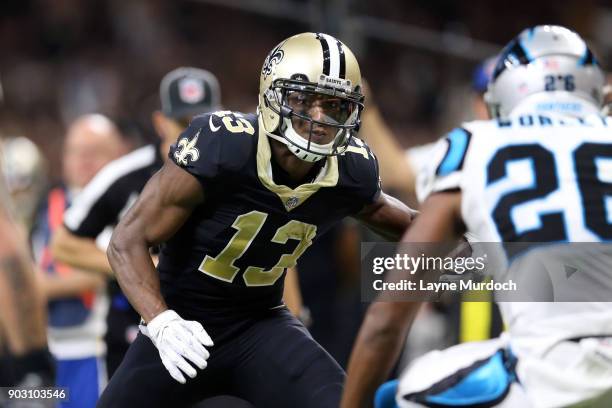 Michael Thomas of the New Orleans Saints runs the ball against Daryl Worley of the Carolina Panthers during the first half of the NFC Wild Card...