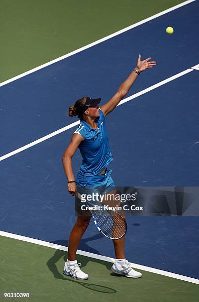 Yanina Wickmayer of Belgium serves to Francesca Schiavone of Italy during Day 2 of the Western & Southern Financial Group Women's Open on August 11,...