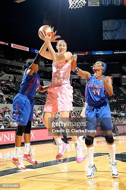 Ruth Riley of the San Antonio Silver Stars comes down with a rebound over Alexis Hornbuckle and Taj McWilliams of the Detroit Shock during the WNBA...