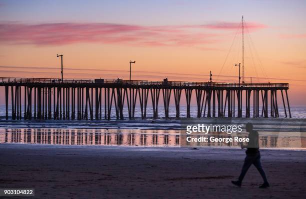 The sun sets behind the pier in this coastal community on December 20 in Pismo Beach, California. With its close proximity to Southern California,...