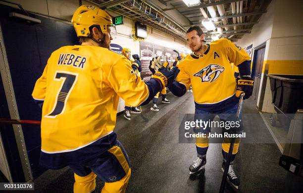 Ryan Johansen and Yannick Weber of the Nashville Predators prepare for warmups against the Edmonton Oilers prior to an NHL game at Bridgestone Arena...