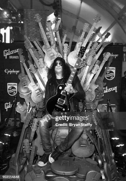 Recording artist Slash holds a one of a kind "Gibson Les Paul Slash Anaconda Burst" guitar presented to him during the Gibson rocks opening of CES...