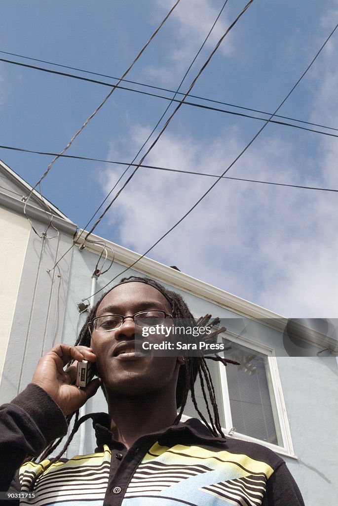 Man outdoors using cellphone.