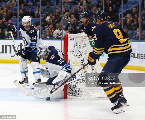 Steve Mason of the Winnipeg Jets makes the save against Evander Kane of the Buffalo Sabres in the second period at the KeyBank Center on January 9,...
