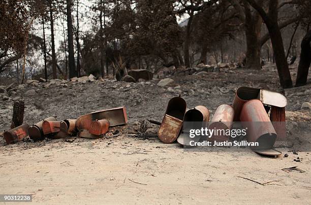 Row of burned mailboxes sit on the ground near homes that were burned by the Station Fire September 2, 2009 at Vogel Flats near Tujunga, California....