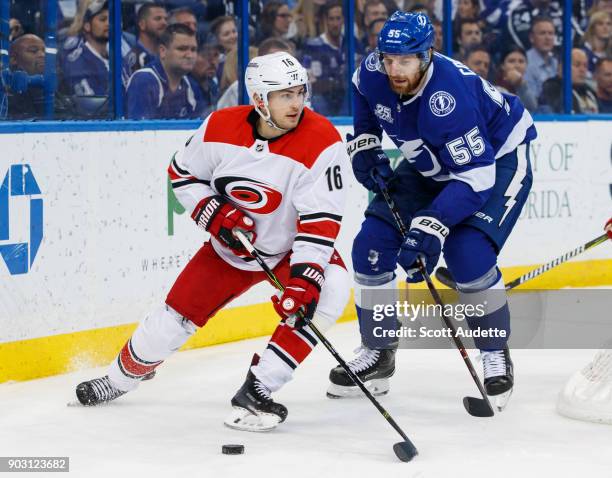 Braydon Coburn of the Tampa Bay Lightning skates against Marcus Kruger of the Carolina Hurricanes during the second period at Amalie Arena on January...